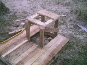 Construct sturdy seat on legs.(remove dangerous splinters)