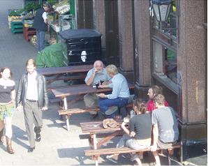 Pub banter continues apace, while young lover stroll and a gent chooses some nice fresh papaya 500 metres from the cordoned off Hackney Road