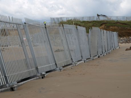 crooked fencing falling into the sea