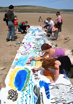 A collaborative art project on the beach next to the camp