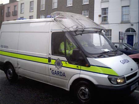 The Garda van arrives down.