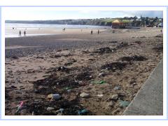 Tramore beach with washed up lwaste from dump