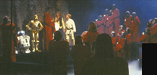 Han, Luke, Leia, etc gather around for the "Life Day" ceremony