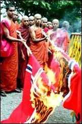 Buddhist monks burn Norwegian Flag