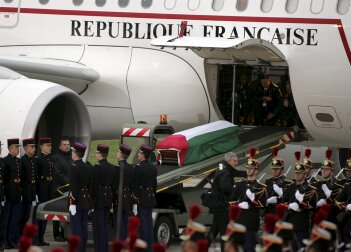 Yasser Arafat's flag draped coffin is brought from Paris to Egypt for his funeral 11-11-2004