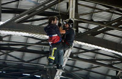 This man is Irish. He climbed up there to demand a ticket home. He's now in a psichiatric unit.