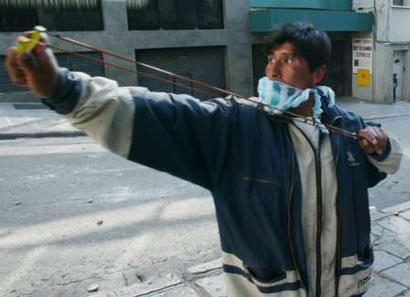 protester throws a stone.