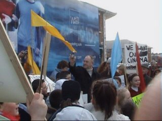 Local politician Pat Black holds up his phone to let local station here protestor's chants