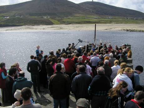 marchers gather on the pier in Rossport for words and reflection