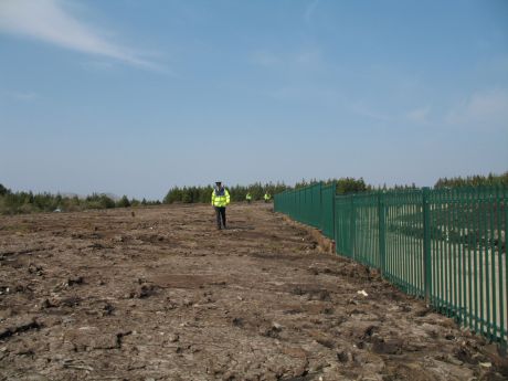 The cops chase some of the women across the site before escourting them off the site. 