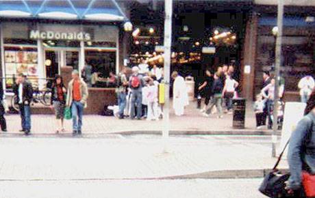 people pausing from shooping to break bread