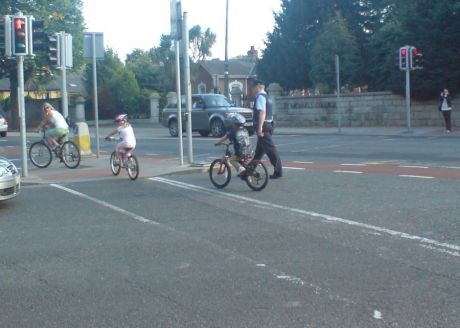 A cop helping some kids across the road (this is D4 after all)