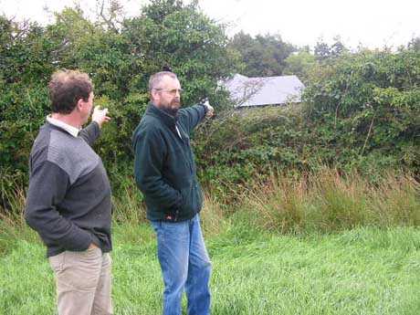 Micheal and Frank pointing to a proposed site for a pylon, note the adjoining house