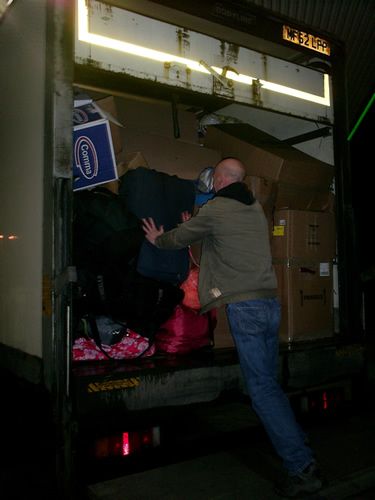 Paul packing the last few bags of childrens toys into the truck