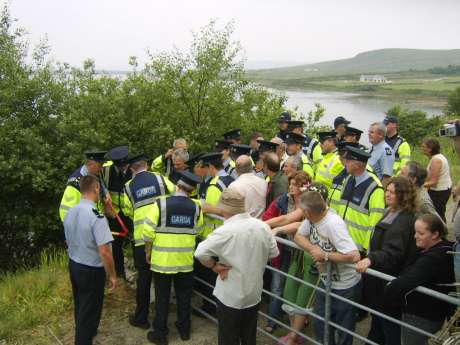 Police use bolt cutters to open the gate. 