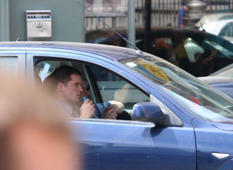 Two uniformed gardai in an unmarked car pointed out protestors and made notes