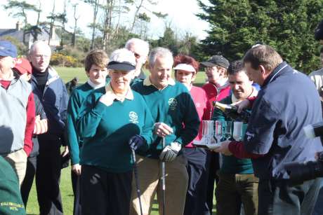 Sean O'Hanlon pours champagne before captains', Ann Davey and Michael Shields, drive-in in Greenore Golf Club