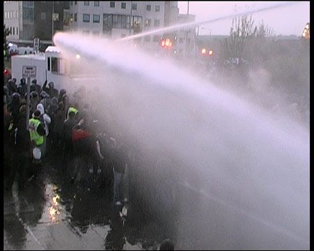 Water Cannon blasts journalists on wall