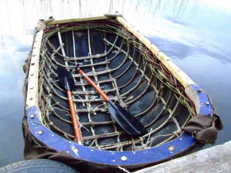 Stuart McIntyres coracle, still under construction, hits the water with confidence.