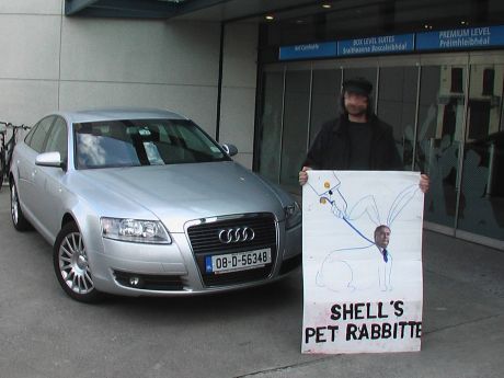 Campaigner infront of Pat Rabbitte's car as he addresses Energy conference