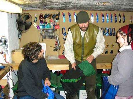 Tracey with Huw and Richard in the Greenpeace climbing equipment store